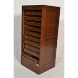 An early 20th century Edwardian oak tambour fronted office filing cabinet having pull out drawer