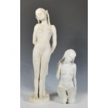 Two 20th Century blanc de chine ceramic bisque figurines depicting nude women having plaited hair to