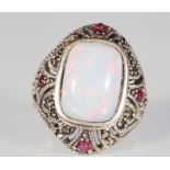 A silver and marcasite ring having a central opal panel on a decorative mount with red accent
