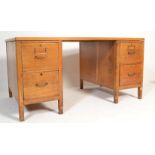 A 20th Century 1940's Industrial Air Ministry style oak twin pedestal office desk having a bank of