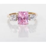 An English hallmarked 9ct gold ladies dress ring set with a central rectangular cut pink stone
