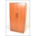 A G-Plan 20th Century teak wood double door wardrobe in the ' Fresco ' pattern. Raised on plinth