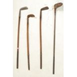 A collection of four vintage early 20th Century golf clubs, three fitted with Hickory shafts to