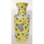 A Chinese antique porcelain baluster vase having a yellow ground decorated with hand painted peonies