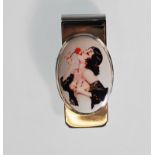 A silver paper / money clip having a central oval enamel panel depicting semi nude lady kissing a