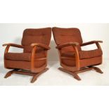 A matching pair of vintage 20th Century 1940's wingback rocking chair- armchairs. Each chair being