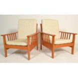 A pair of 20th Century vintage retro teak wood framed lounge arm chairs having a slatted backrest