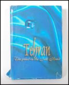 A large book entitled Tehran The Jewel on The silk