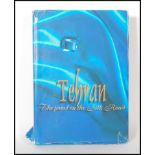 A large book entitled Tehran The Jewel on The silk