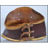 A 20th Century two tone leather medical back brace