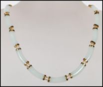 A Chinese jade spacer necklace constructed from 16