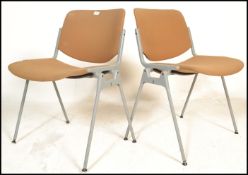 A pair of mid century retro office chairs having f