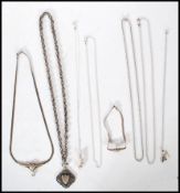 A group of silver necklace chains and pendants to