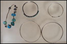 A selection of silver bracelets to include a bangl