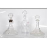 A group of three 20th Century cut glass decanters.