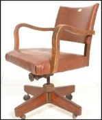 A 1930's Art Deco oak framed swivel desk chair hav