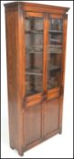 An early 20th Century Edwardian oak bookcase, glaz