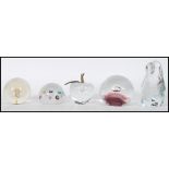 A collection of glass paperweights to include a li