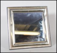 A 20th Century silver framed easel back mirror hav