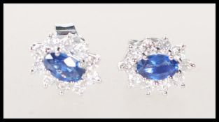 A pair of 18ct white gold earrings set with centra