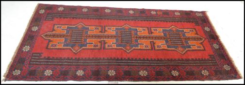 A hand knotted woolen Herati Baluchi carpet floor