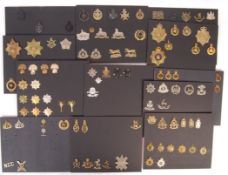 COLLECTION OF ASSORTED MILITARY UNIFORM CAP BADGES