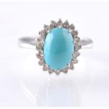 AN 18CT WHITE GOLD TURQUOISE AND DIAMOND OVAL CLUS