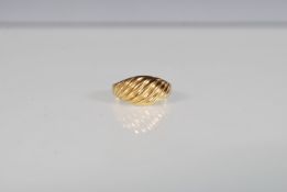 A hallmarked 9ct yellow gold ring of twist design.