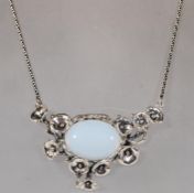 A substantial silver pendant necklace set with a c