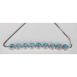 A stunning silver line bracelet set with nine blue