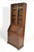 An early 20th Century oak bureau bookcase, glazed