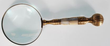 A 20th Century brass hand held magnifying glass wi
