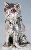 A silver pincushion in the form of a cat having an