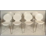 A set of Galvano Tecnica Italian white plastic formed shell dining stacking chairs having a shell