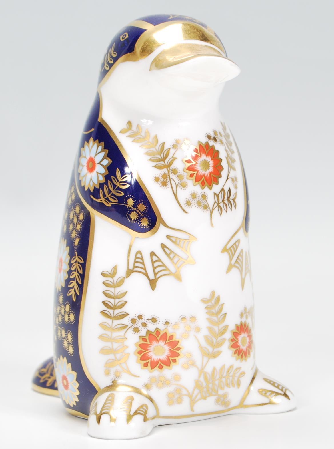 A Royal Crown Derby porcelain figurine of a Platypus in poly-chrome colourways, stamped to the