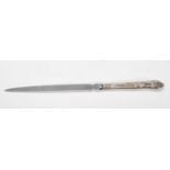 A silver hallmarked Harris Brothers letter opener having scrolled embossed handle. Hallmarked