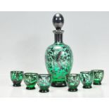 A Bohemian green glass decanter and stopper overlaid with silver white metal together with six
