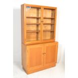 A mid century golden oak library bookcase cabinet in the manner of Air Ministry style furniture.