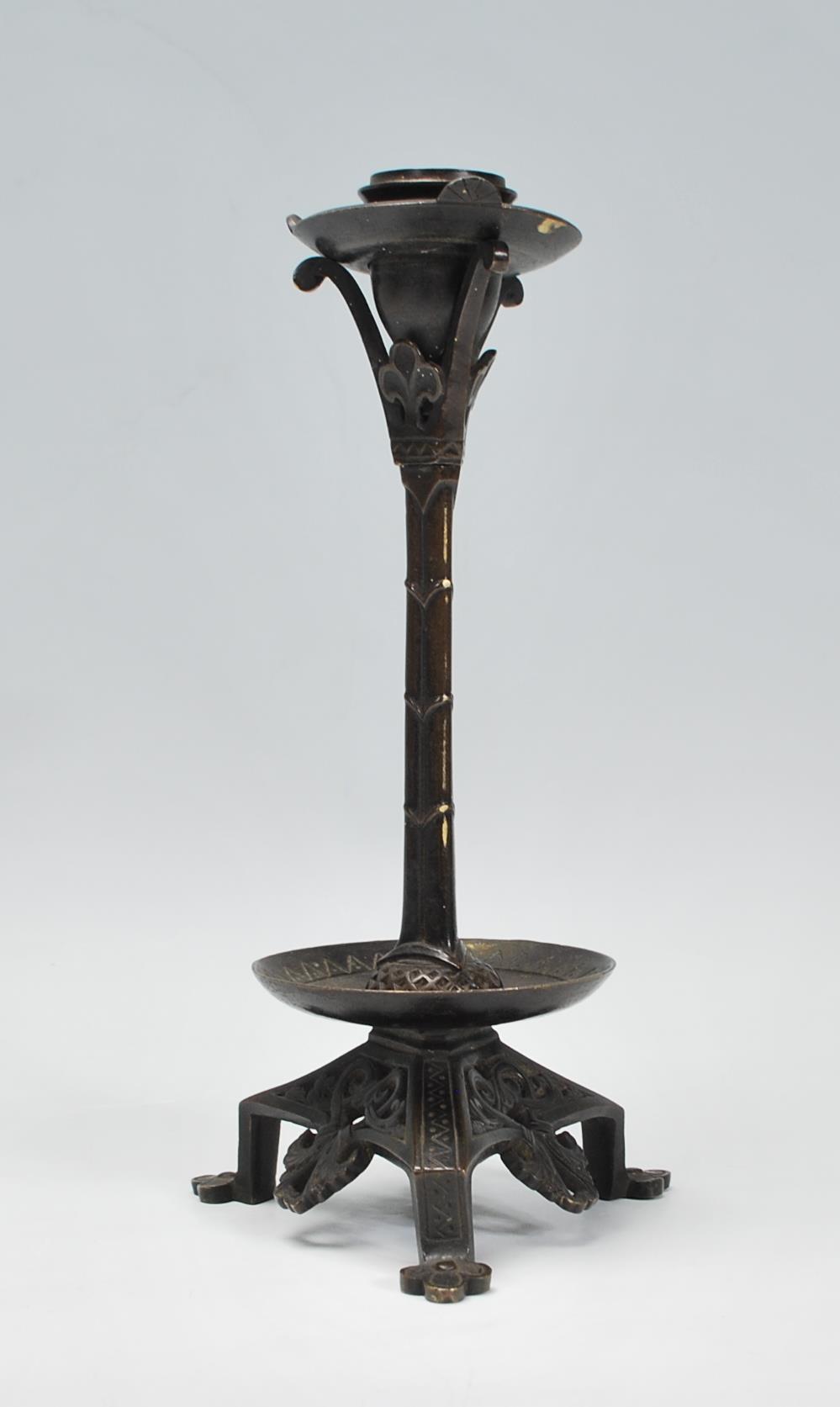 A late 19th / early 20th Century Arts and Crafts case bronzed candlestick raised on a tripod base - Image 3 of 7
