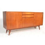 A mid 20th century believed Danish teak wood sideboard / credenza  being raised on turned legs