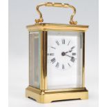 An early 20th century brass cased carriage clock  having inset enamel face with roman numeral