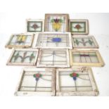 A collection of 11 early 20th century stained glass window panels. Of varying sizes with colourful