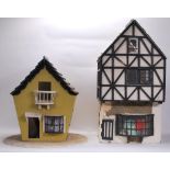 A vintage 20th Century Tudor style dolls house having three levels with a selection of dolls house