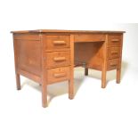 A mid century Air Ministry style Industrial office desk being raised on squared legs with a series