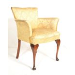 A 1930's Art Deco walnut bedroom armchair in the Queen Anne manner. Raised on tall tapering legs