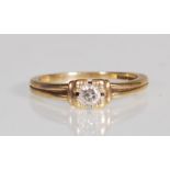An English hallmarked 9ct gold ring set with a brilliant cut diamond within a square mount having