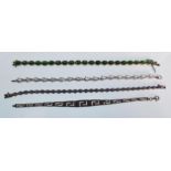 A group of four stamped 925 silver bracelets to include three tennis bracelets set with white, lilac