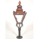 A 19th Century Victorian street light of copper construction with mottled glazed panels and finial