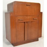 A 20th Century Art Deco walnut cocktail cabinet. Fall front cabinet over drawer and cupboards raised