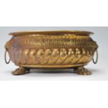 A 19th Century Victorian brass planter of oval having gadrooned decoration to the sides with lion